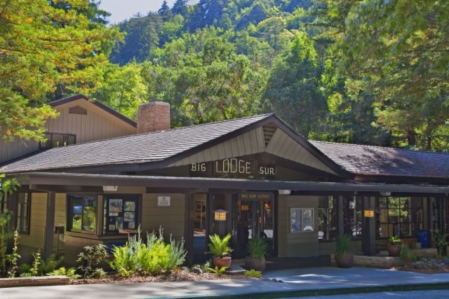 Exterior of the Big Sur Lodge surrounded by lush green trees