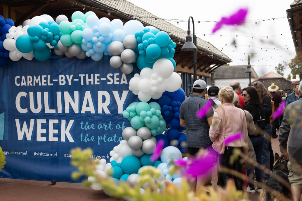 Welcome sign and multi-colored blue, silver and white balloons for Carmel Culinary Week in Carmel-by-the-Sea, CA