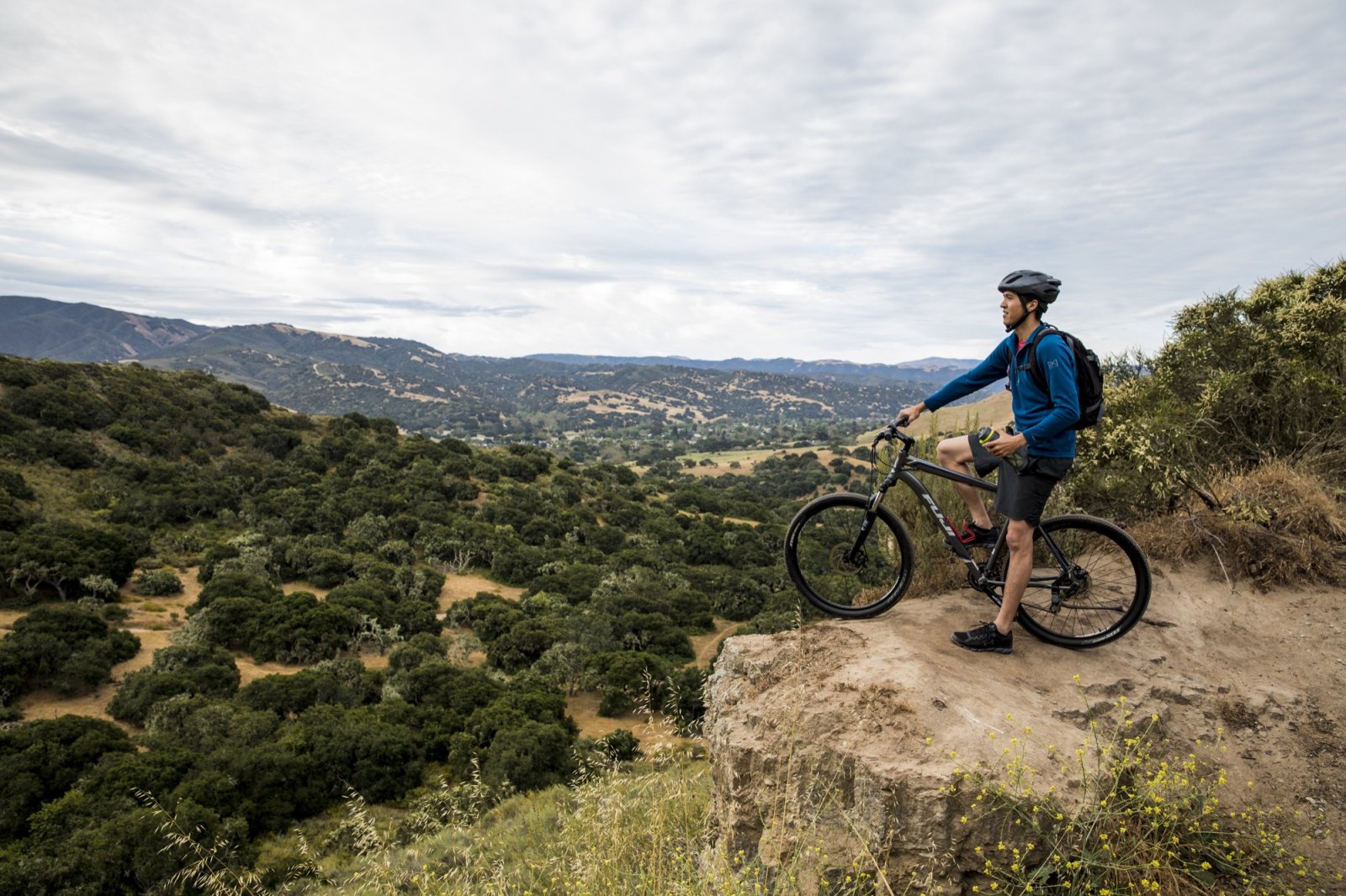 Man on bike on rock in Fort Ord National Monument in Marina