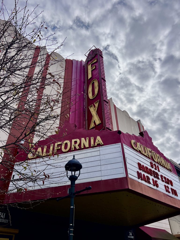 Old theater with FOX neon sign and california written on building