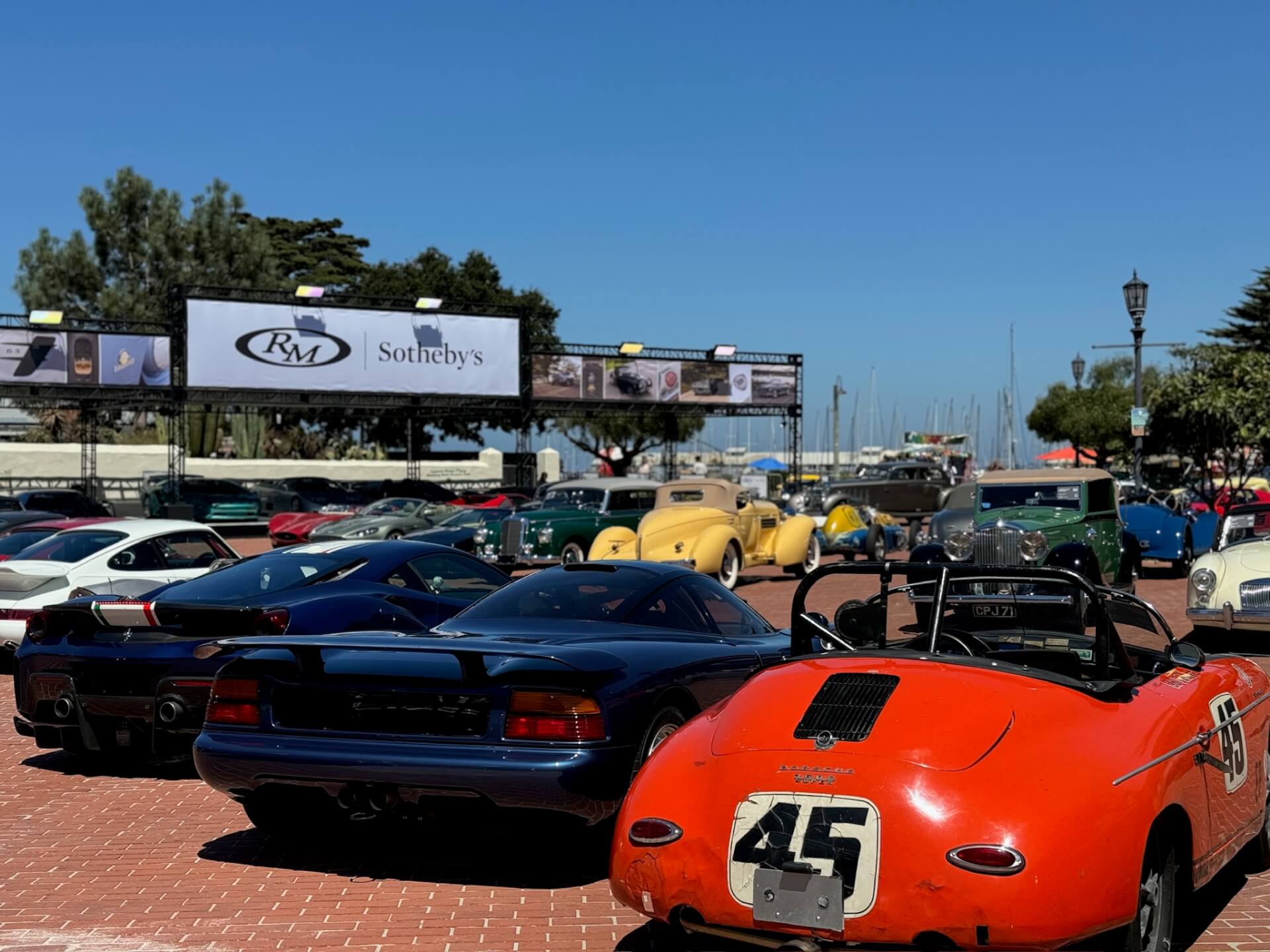 Classic cars on display outdoors in the plaza in front of Monterey's Old Fisherman's Wharf