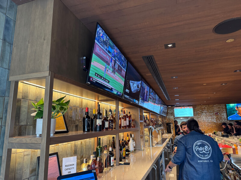 Interior bar at Peter B's Brewpub with several TVs